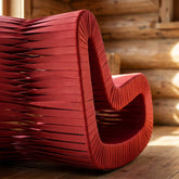 Close-up of the braided backside and woven fabric straps of the Seat Belt Rocking Chair, highlighting intricate braiding and texture.