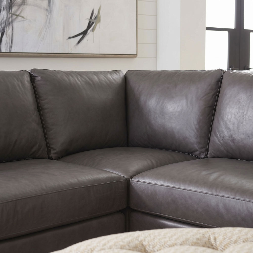 Close-up of Belmont sectional sofa corner, emphasizing stitching, fabric texture, and craftsmanship with neutral background.