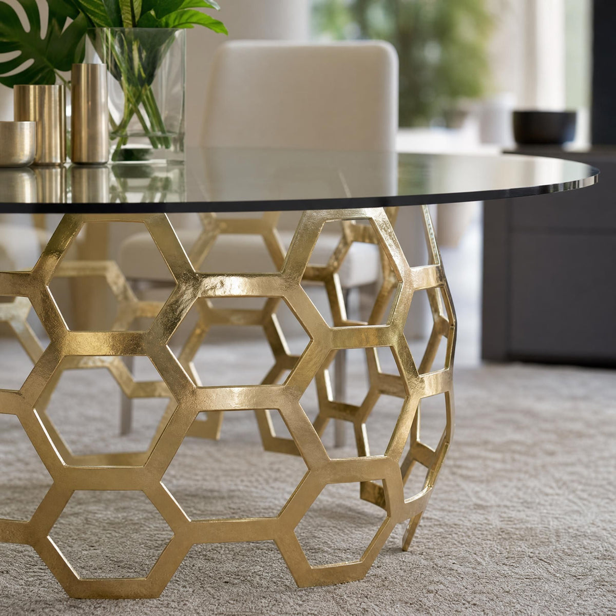 Close-up angled view of Dolma Dining Table edge, emphasizing seamless glass integration and reflective brass surfaces.