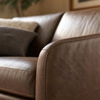 Macro shot of the Frannie Leather Sofa's upholstery focusing on grain, stitching, and subtle creases.