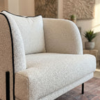 Close-up of Giroud Chair’s upholstered seat and backrest, emphasizing fabric texture and sophisticated proportions in a lounge setting.