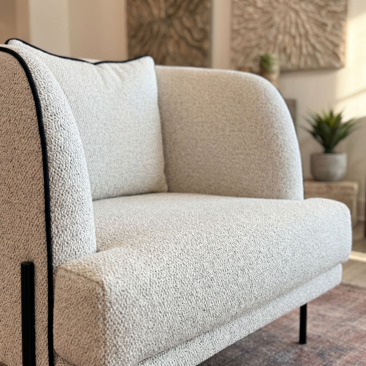 Close-up of Giroud Chair’s upholstered seat and backrest, emphasizing fabric texture and sophisticated proportions in a lounge setting.