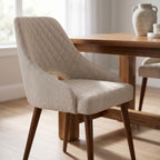 Close-up of the Herchel Dining Chair showcasing textured high-performance fabric upholstery in a modern dining room setting.