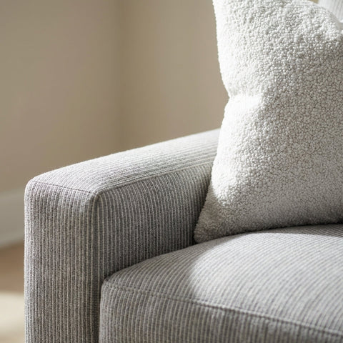 Macro shot of the NEST SOFA highlighting its textured fabric surface with soft natural lighting and blurred background.