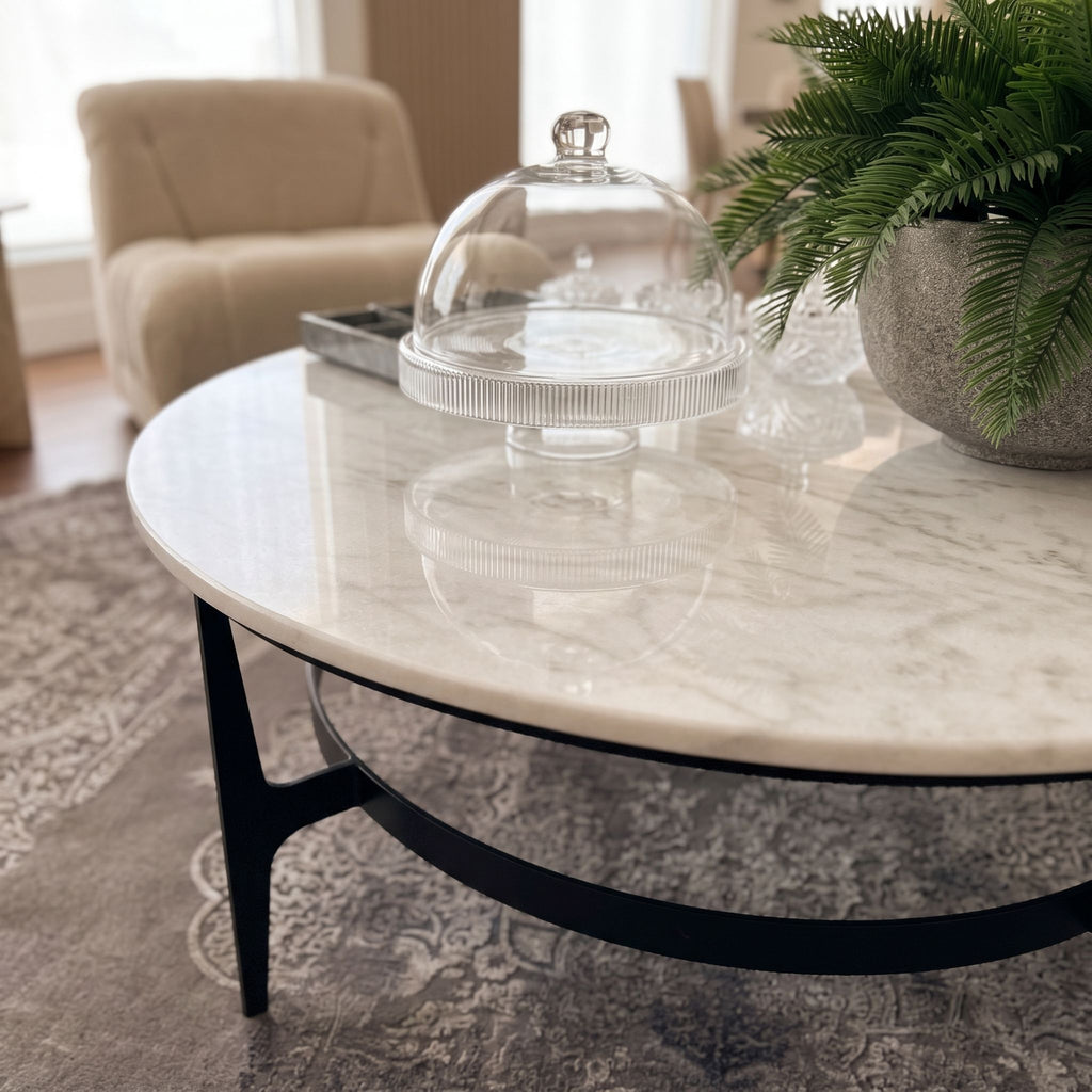 Close-up of Dena Coffee Table's white marble top with detailed veining and polished surface, in a modern living room setting.