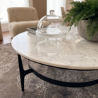 Close-up of Dena Coffee Table's white marble top with detailed veining and polished surface, in a modern living room setting.