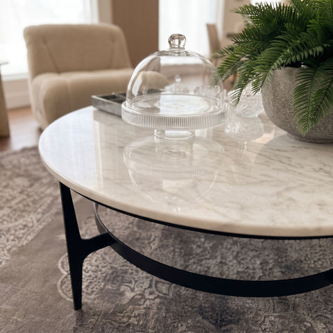 Close-up of Dena Coffee Table's white marble top with detailed veining and polished surface, in a modern living room setting.