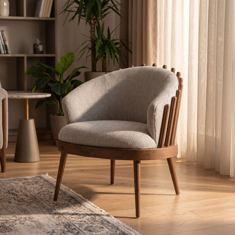 Reveal Chair in a contemporary lounge, illuminated by afternoon sunlight on hardwood floor with blurred background.