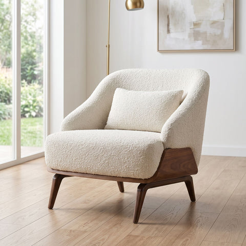 Full-body view of Eva Lounge Chair placed next to a window in a contemporary living space with natural daylight.