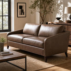 Close-up of the Frannie Leather Sofa showing textured leather grain in a sunlit modern living room.