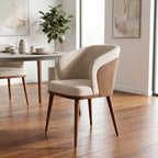 Laurent Dining Chair from a front-side angle in a minimalist dining room, highlighting fabric quality and wood finish.
