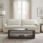 Full perspective of Lowell Sofa in ivory leather with neutral decor in a well-lit living room.