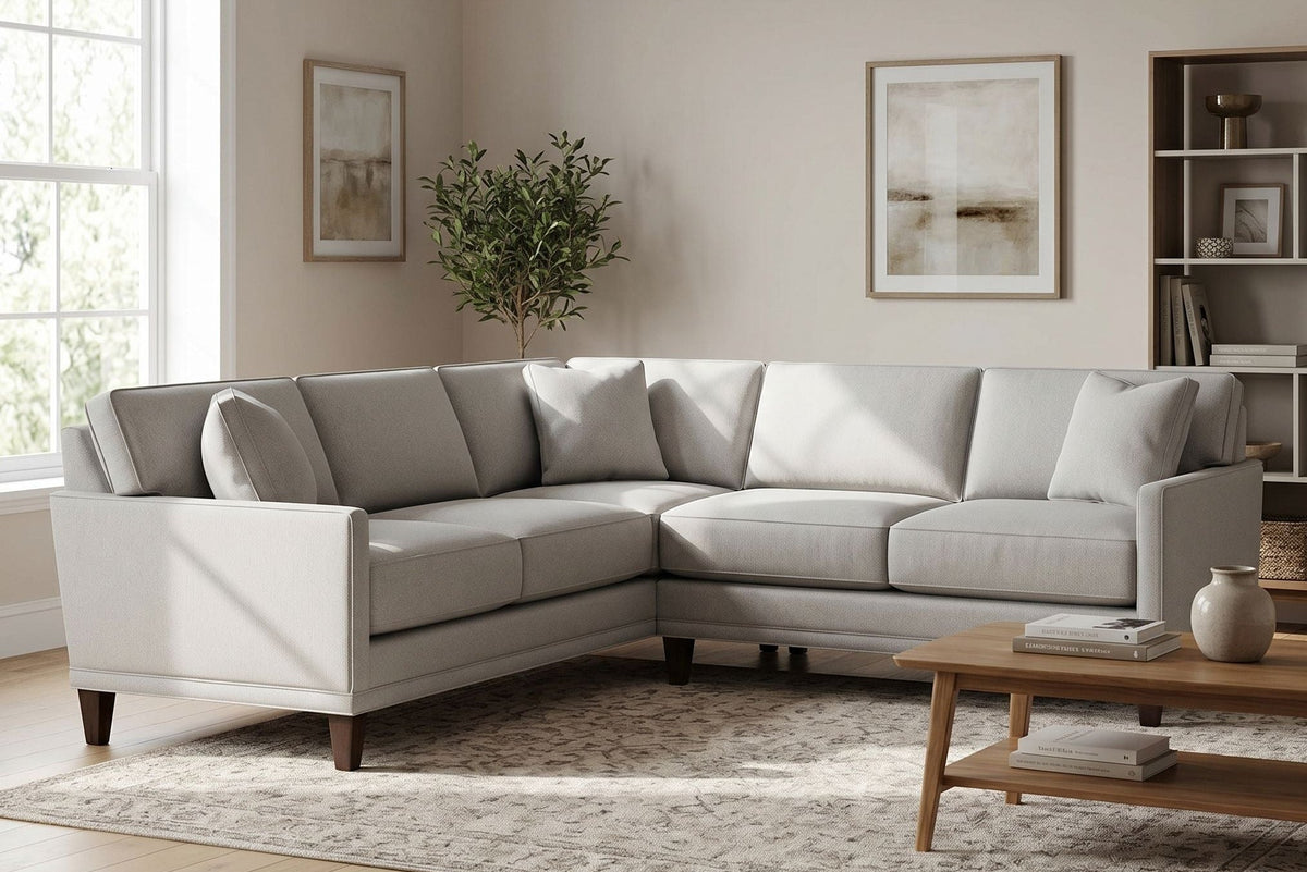 Full scene of Townsend Sectional in a chic living room highlighting its size, craftsmanship, and plush cushions with neutral decor.