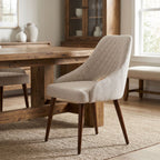 Full view of Herchel Dining Chair with polished wooden frame in a warm, inviting dining room scene with rustic table and natural light.