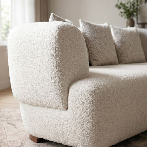 Close-up of the Huxley sofa's fabric upholstery highlighting its rich texture and subtle weave pattern with natural light.
