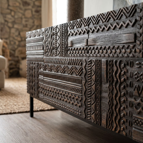 Close-up of the Intaglio Credenza highlighting solid wood doors and textured veneer in a natural-lit living room.