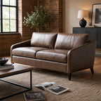 Lifestyle scene of the Frannie Leather Sofa styled in a cozy living space with warm lighting and rustic decor.