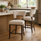 Lifestyle scene of Barrow fabric counter stool at a breakfast bar in a lived-in kitchen setting.