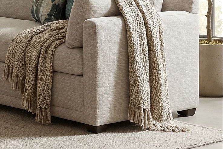 Full scene of Sylvie Bench Seat Sectional in a modern living room with textured wall and ambient daylight.