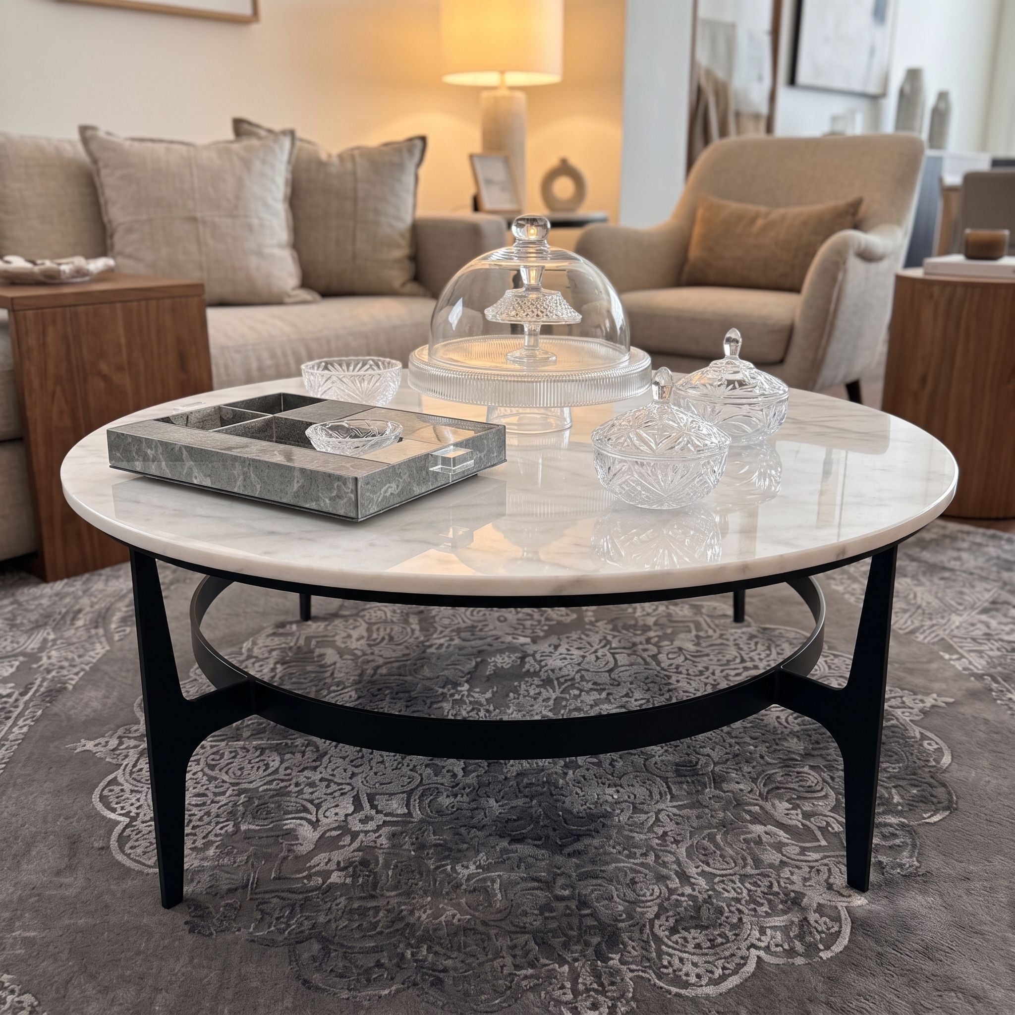 Side angle of Dena Coffee Table in a stylish lounge, highlighting marble veining and organic black metal base.