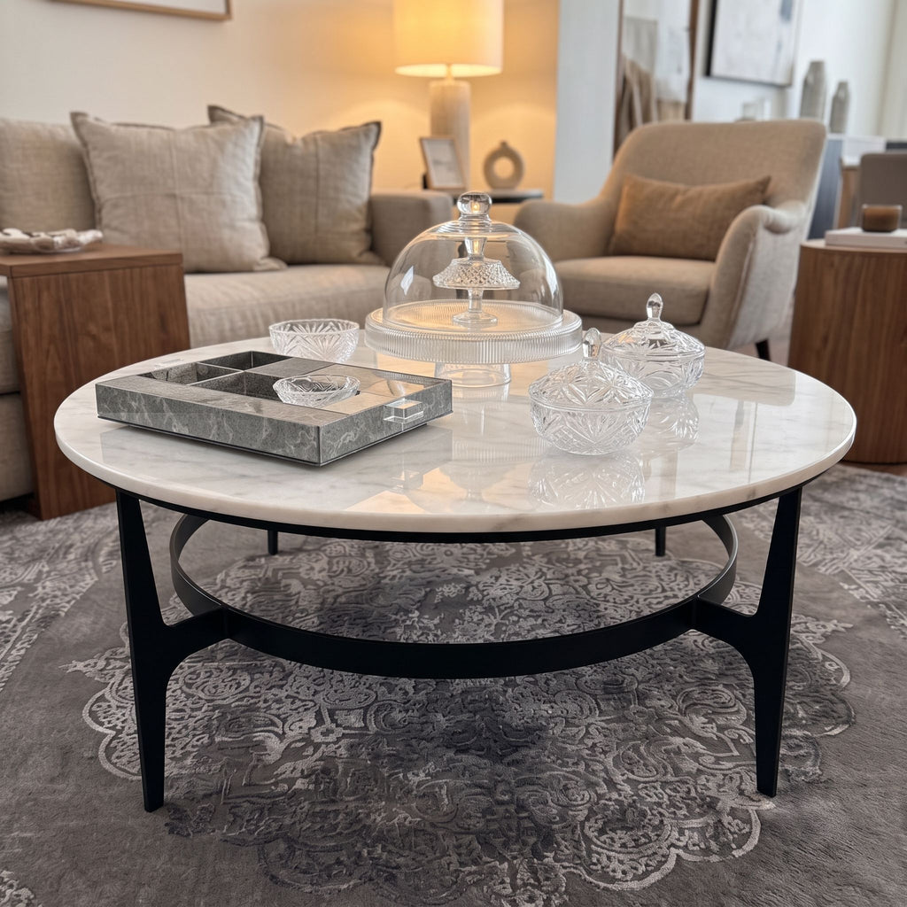 Side angle of Dena Coffee Table in a stylish lounge, highlighting marble veining and organic black metal base.