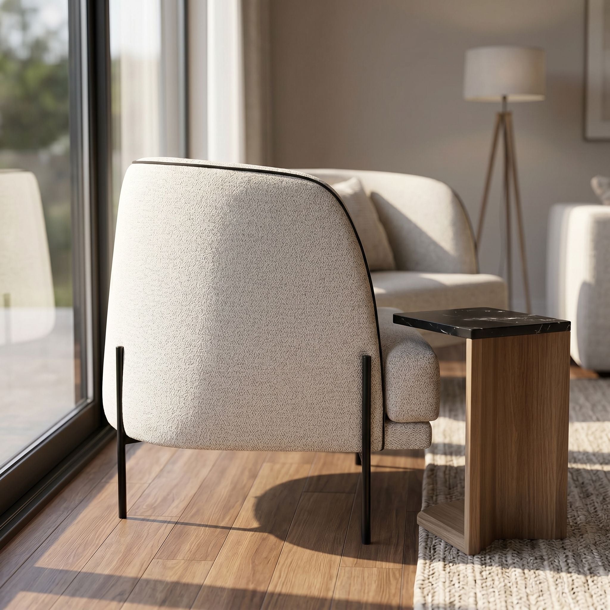Side profile of Giroud Chair next to a modern side table, emphasizing its elegant shape and clean lines in a bright airy space.