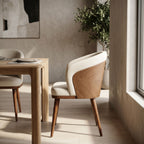 Side profile of Laurent Dining Chair with stain-resistant upholstery against a textured neutral wall in a modern dining space.