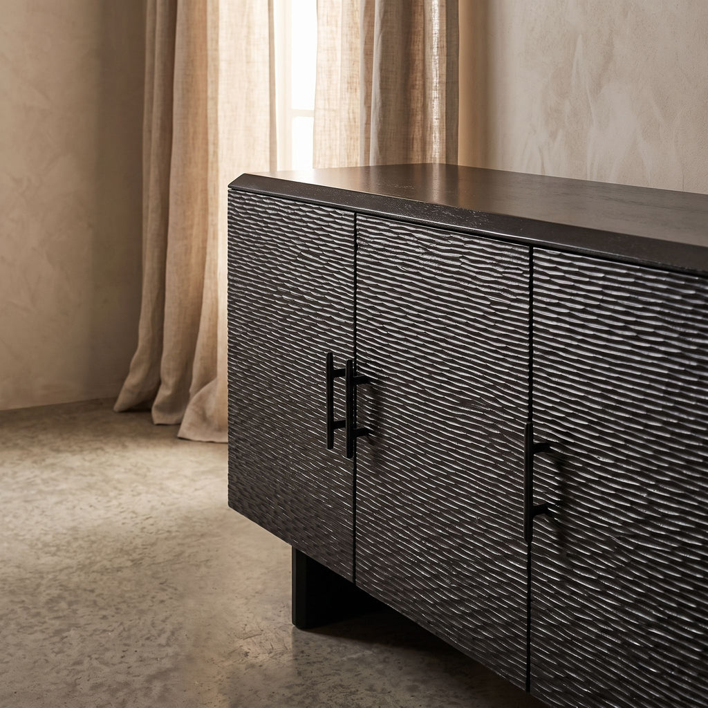 Close-up of the Silvanos Sideboard showcasing its black lacquered mango wood surface and soft-close doors with a glossy finish.