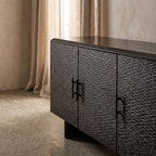 Close-up of the Silvanos Sideboard showcasing its black lacquered mango wood surface and soft-close doors with a glossy finish.