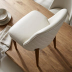 Overhead artistic view of Stitches dining chair showing diamond tufting pattern and tactile leather surface in a natural wood setting.