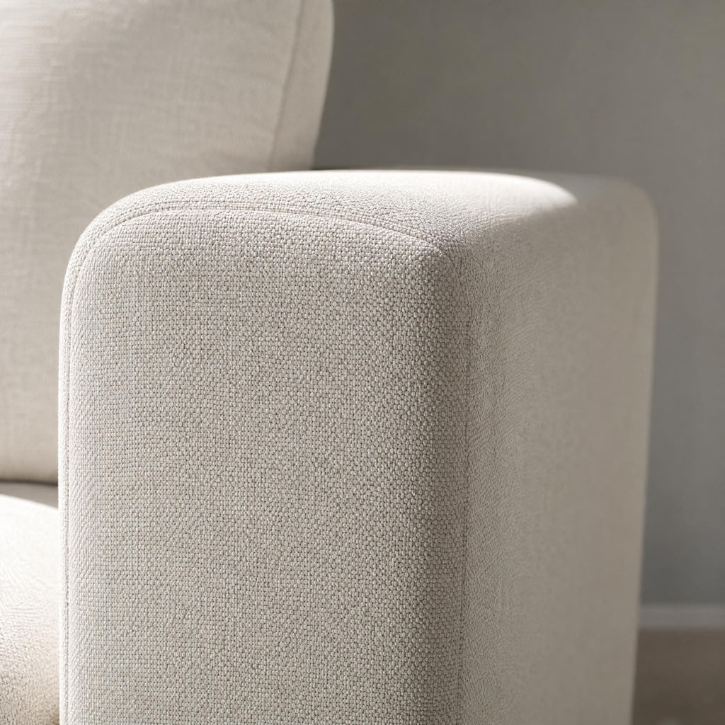 Close-up of durable off-white textured fabric on the armrest of the Stockdale classic sleeper sofa.