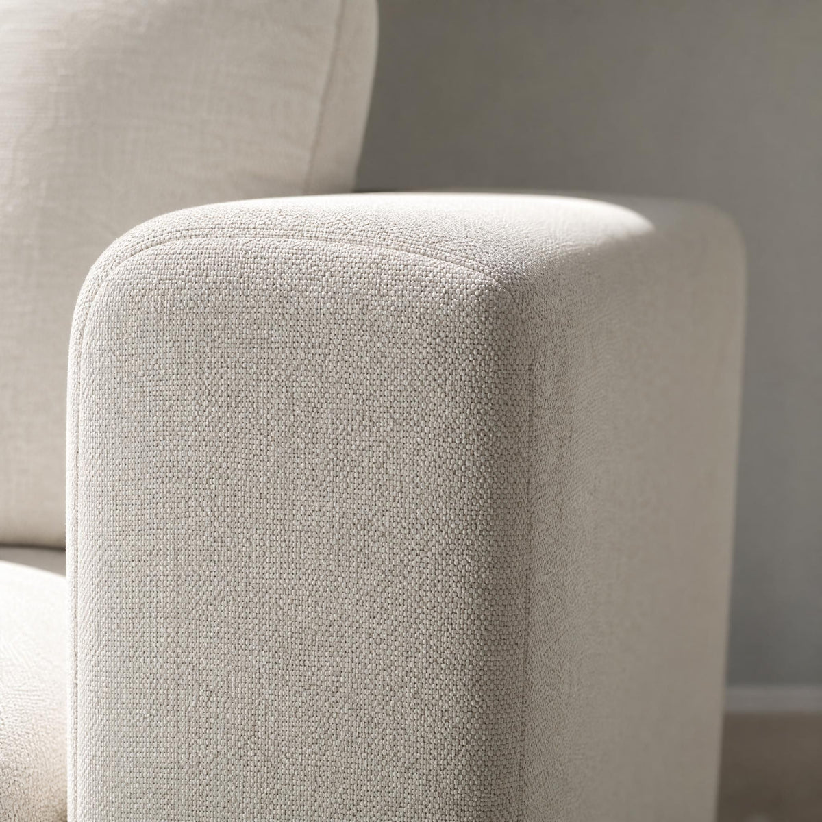Close-up of durable off-white textured fabric on the armrest of the Stockdale classic sleeper sofa.