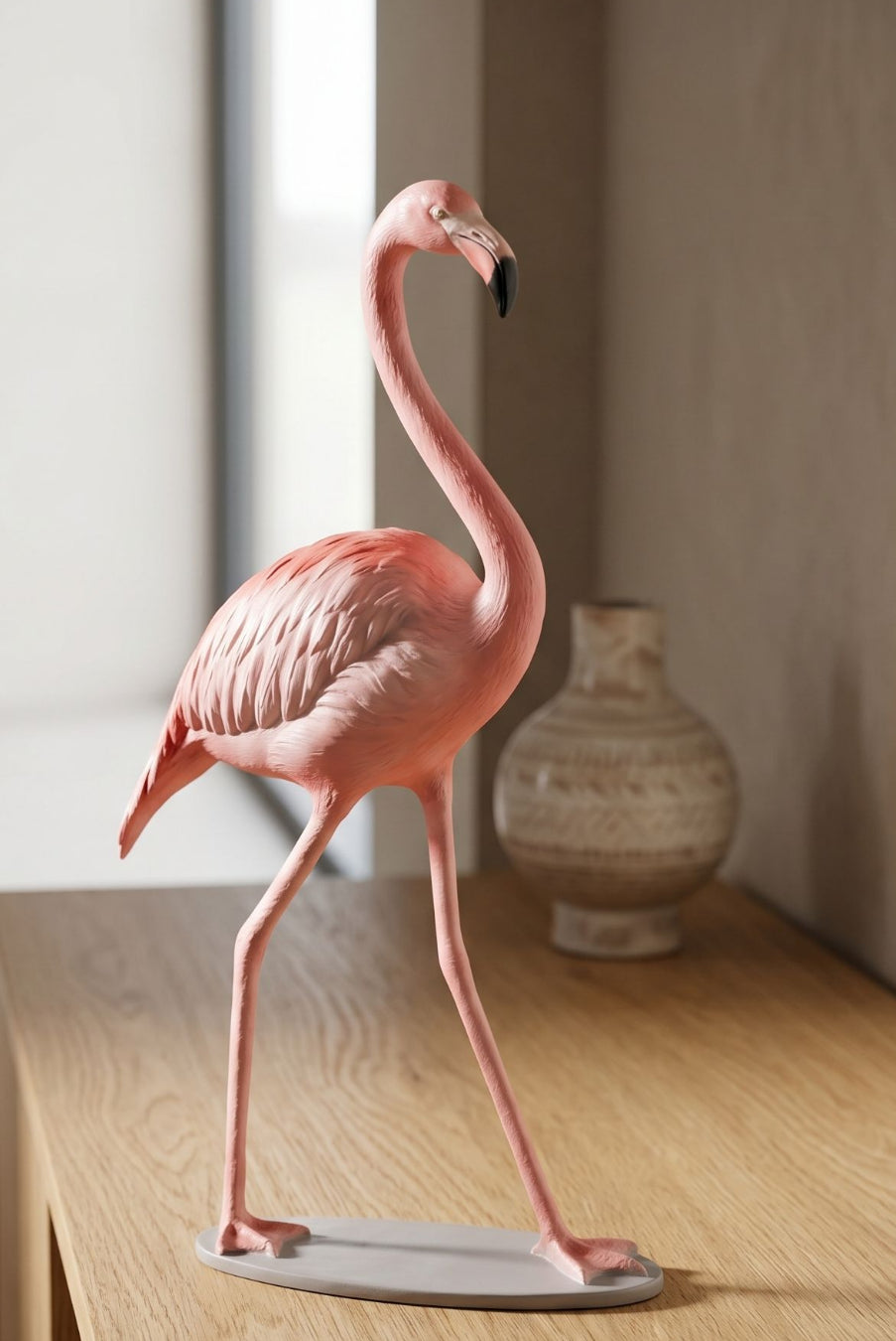 Tiny flamingo sculpture in a stylish modern interior, illuminated by soft cinematic lighting that emphasizes its refined finish and artistic grace.