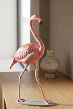 Tiny flamingo sculpture in a stylish modern interior, illuminated by soft cinematic lighting that emphasizes its refined finish and artistic grace.