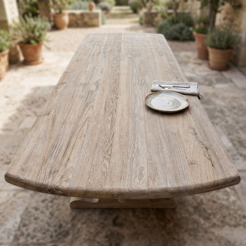 Top-down view of teak table surface focusing on grain and weathered finish, ideal for outdoor dining.